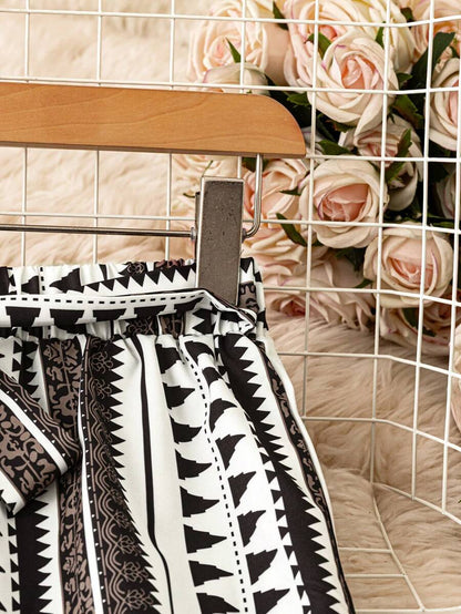 SHEIN LUNE Pantalones anchos de cintura elástica con estampado todo sobre para vacaciones informales